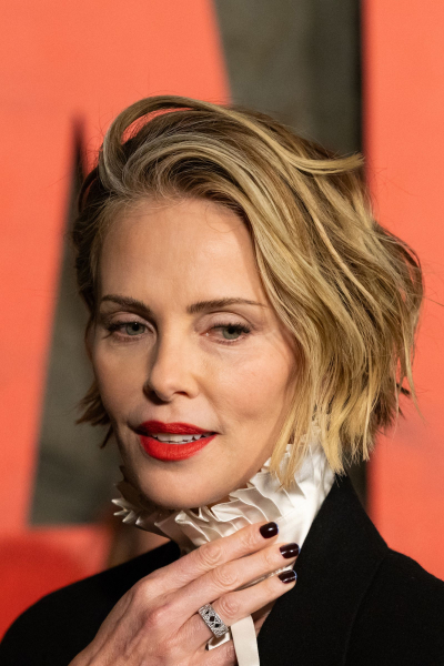 Charlize Theron appears at a premiere with dark nails with a pale blue tip.